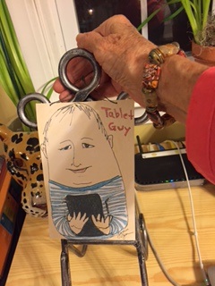 Cousin Julie displays one of her Christmas gifts from me:  a print of my sketch, "Tablet Guy" 